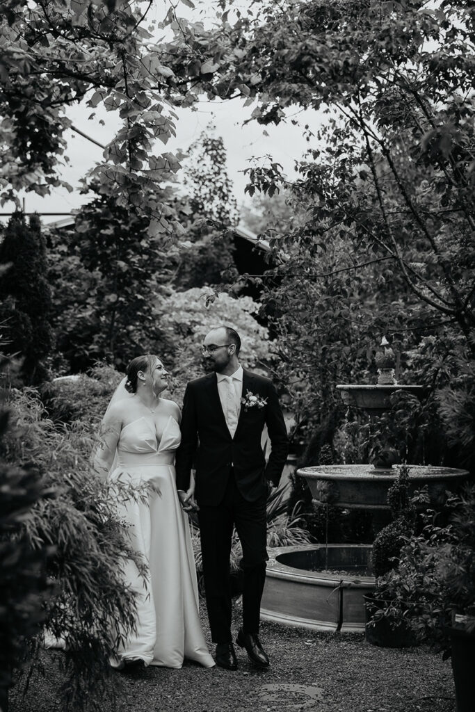 the newlyweds walking around the nursery during their Blockhouse PDX wedding. 