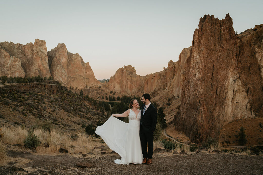 A couple posing in front of Smith Rock during their elopement. 