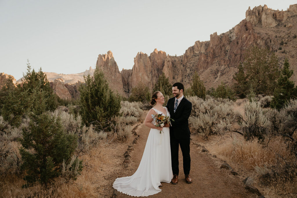 A couple hiking in Smith Rock during their elopement. 