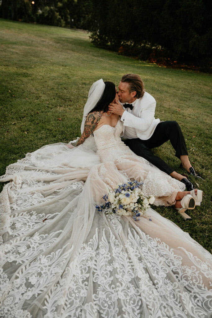 the bride and groom kissing on the grass lawn at Deepwood Museum and Gardens. 