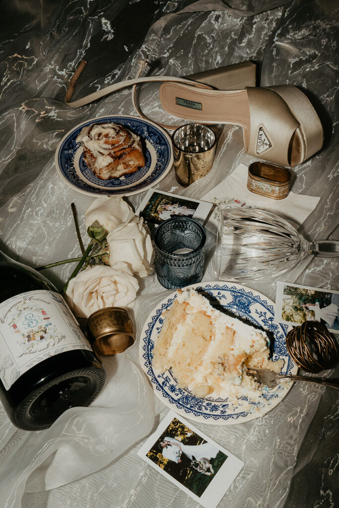 details from the party, including a half-eaten cake, wine bottle and glasses, shoes, and polaroids. 