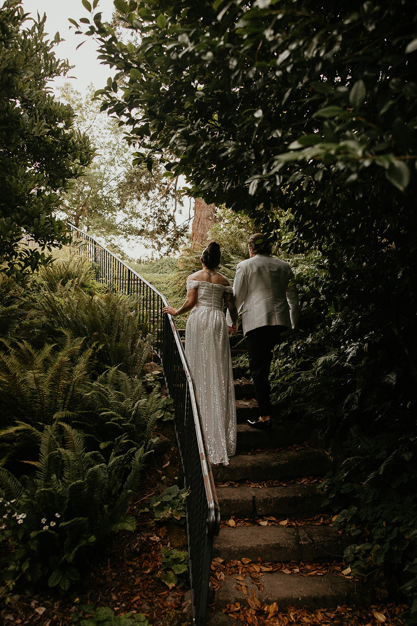 the newlyweds walking up a set of stairs at Deepwood Museum and Gardens. 