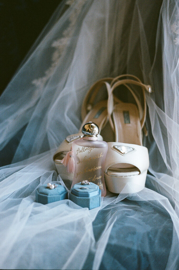 A wedding dress, heals, fragrance, and wedding rings. 