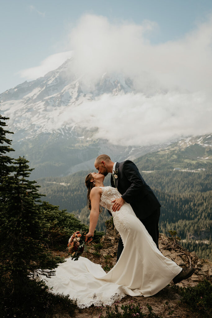 A couple kissing while they elope in Mt Rainier.