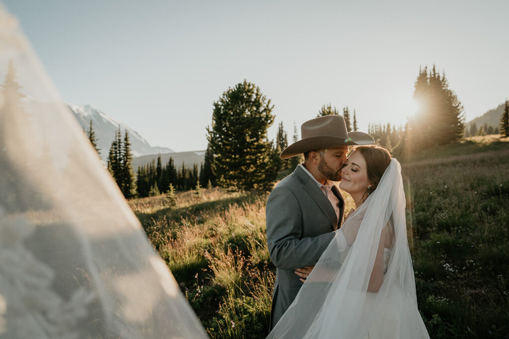 A couple about to kiss at sunset in the mountains. 