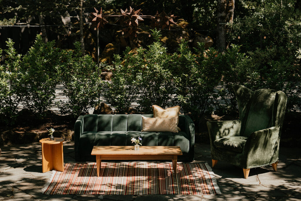 a chair, couch, and several tables outside. 