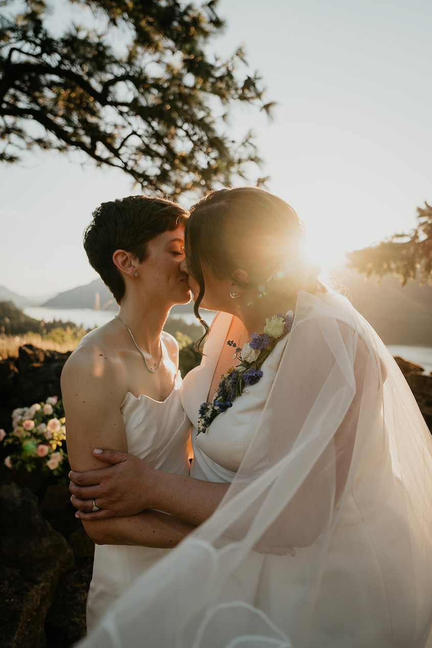 A couple kissing at sunset after getting married at The Griffin House. 