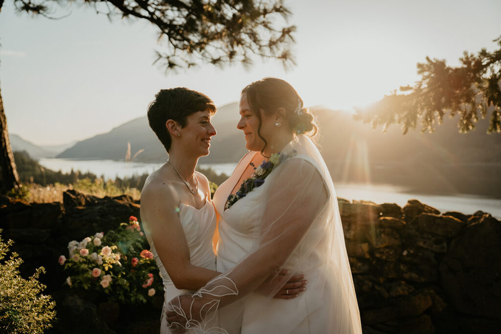 A couple holding hands at sunset at The Griffin House. 