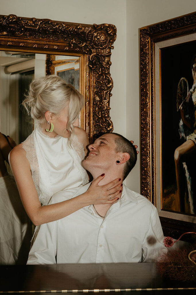 The couple at the piano and looking longingly into each other's eyes. 