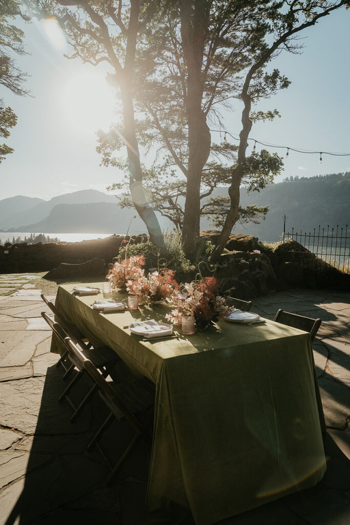 A table set outside with the Columbia River Gorge in the background at The Griffin House. 