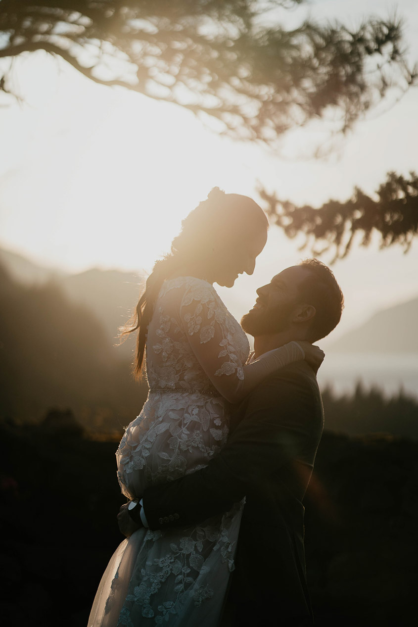 A couple embracing each other at sunset at The Griffin House. 