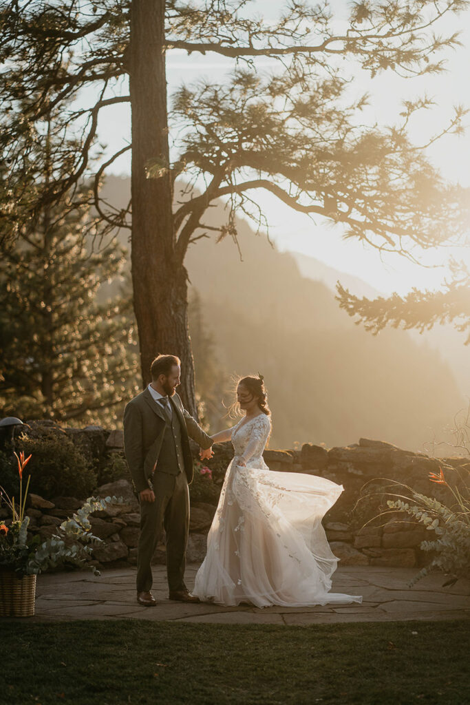 A couple holding hands at sunset at The Griffin House. 