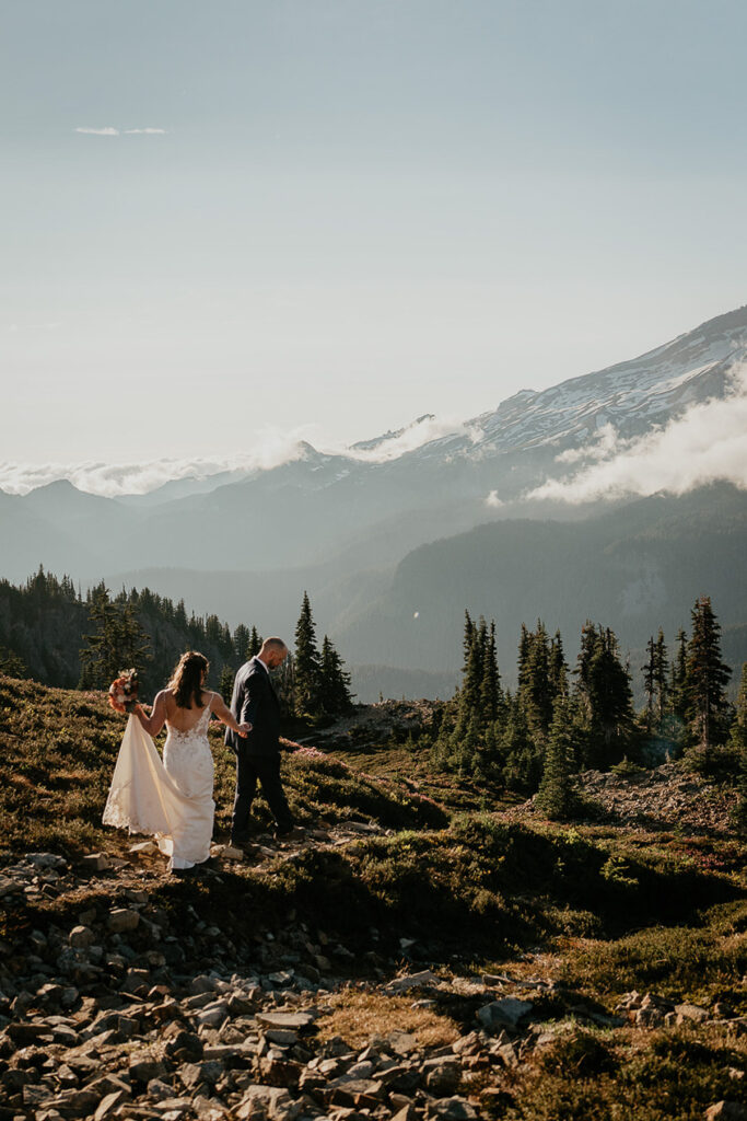 A couple walking on a trail in Mt Rainier during their elopement. 