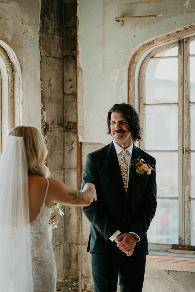 The groom smiling after the first look at The Ruins at the Astor. 