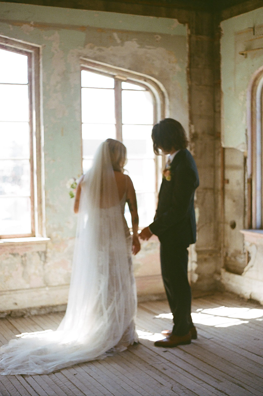 the bride and groom adjusting their wedding day outfits. 