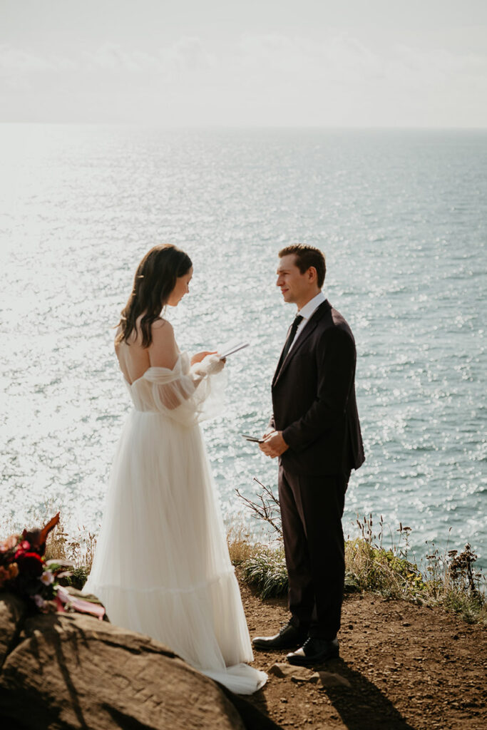 A couple sharing their vows during their Oregon Coast elopement. 