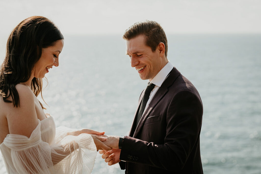 The newlyweds exchanging rings on the Oregon cliffside. 